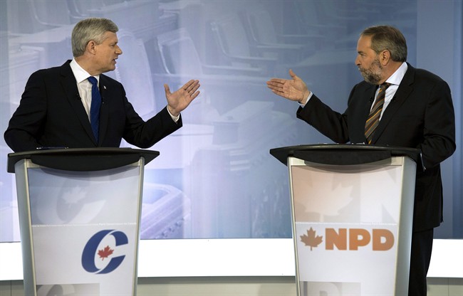 Conservative leader Stephen Harper, left, exchanges words with NDP leader Tom Mulcair during the french language leaders debate Thursday, September 24, 2015 in Montreal.