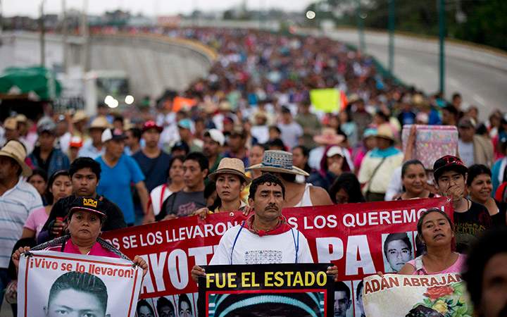 Relatives of the 43 missing Ayotzinapa teachers' college students lead a march marking the one-year anniversary of the students' disappearances in Chilpancingo, Mexico on Sept. 26, 2015.