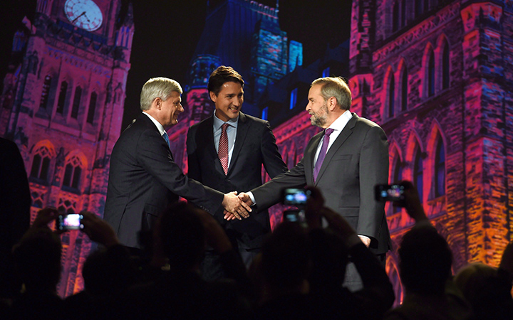 Conservative leader Stephen Harper and NDP leader Tom Mulcair shake hands as Liberal leader Justin Trudeau looks on during their introduction prior to the Globe and Mail hosted leaders' debate in Calgary on September 17, 2015. 