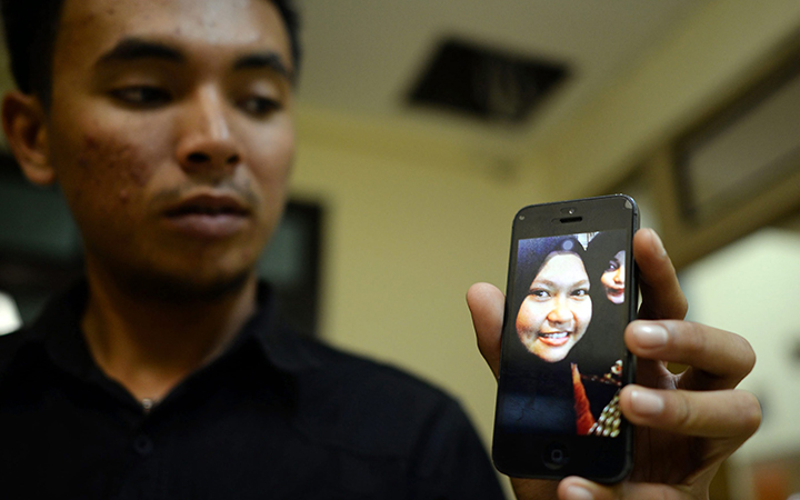 A relative of a passenger on board the missing Aviastar plane shows her picture on his mobile phone at a crisis center in Hasanuddin International Airport in South Sulawesi, Indonesia, 02 October 2015.  