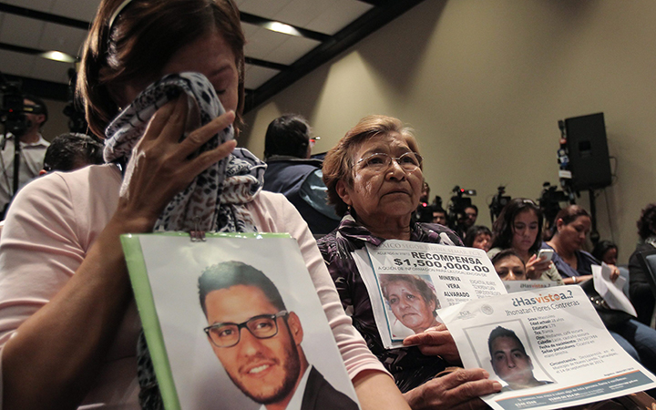 Relatives of the 43 students missing in Iguala since more than a year ago protest to ask for justice during a press conference by experts of the Inter American Commission of Human Rights (CIDH) in Mexico City, Mexico, 02 October 2015.