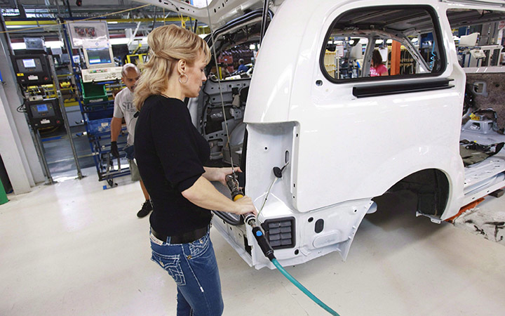 A worker on the production line at Chrysler's assembly plant in Windsor, Ontario, works on one of their new minivans. The auto sector is one of the key sectors that were involved in the negotiations for the Trans-Pacific Partnership deal.
