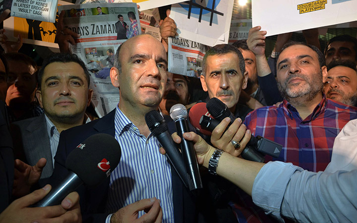 Abdulhamit Bilici, editor-in-chief of Zaman newspaper, speaks to the media minutes before police detain Bulent Kenes, editor-in-chief of Today's Zaman, right, in his office in Istanbul, Turkey, late Friday, Oct. 9, 2015. 