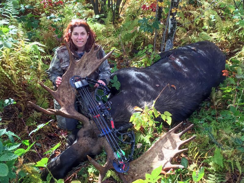 In this Oct. 2, 2015, photo provided by Tammy Miller, Miller, of Fairfax, Vt., poses with a moose taken on a hunting trip in Vermont.