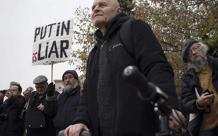A protester holds a banner during an anti-war rally in Moscow, Russia, Saturday, Oct. 17, 2015. 