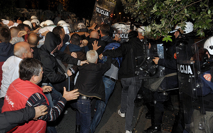 Anti-government protesters clash with Montenegrin police officers in Podgorica, Montenegro, Saturday, Oct. 17, 2015.