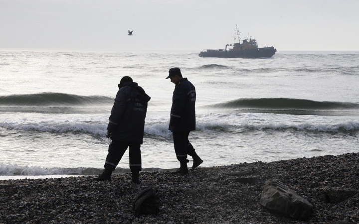 Ukrainian police officers investigate the coast near to where the boat Ivolga capsized on Saturday, Oct. 17, in a storm near the major port city of Odessa, Ukraine, Sunday, Oct. 18, 2015. 