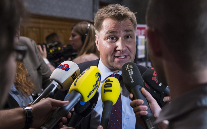The president of Switzerland's leading party, the right wing SVP, Toni Brunner, center, talks to the media after national elections in Bern, Switzerland, Sunday, Oct.18, 2015.