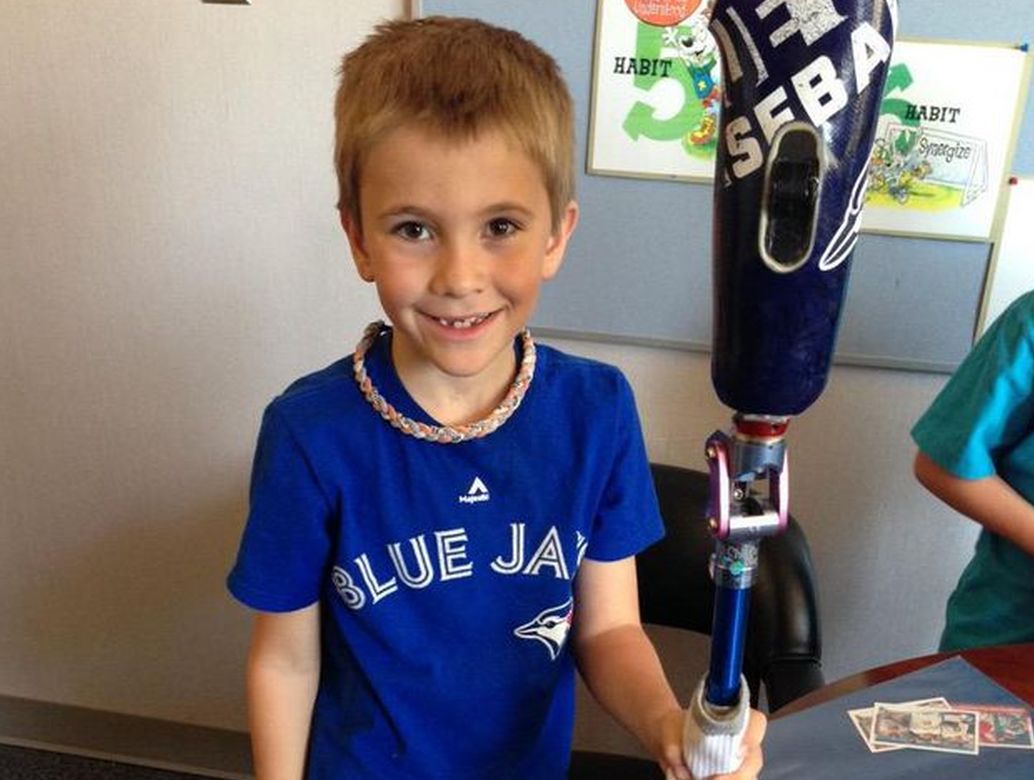 Roan Heck shows off his prosthetic leg that the Blue Jays signed earlier this season.