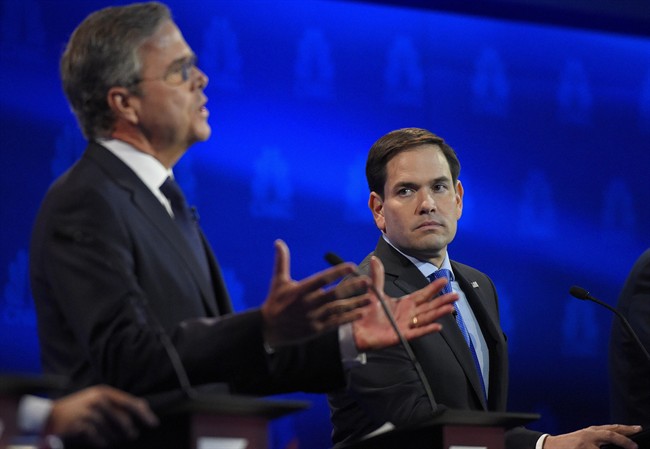 Marco Rubio, right, watches as Jeb Bush speaks during the CNBC Republican presidential debate at the University of Colorado, Wednesday, Oct. 28, 2015, in Boulder, Colo. 