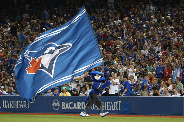 Toronto Blue Jays mascot Ace waves a large team flag during a break in the MLB game against the Oakland Athletics on August 11, 2015 at Rogers Centre in Toronto, Ontario, Canada. (Photo by Tom Szczerbowski/Getty Images).