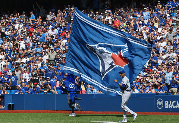 Toronto Blue Jays mascot Ace waves a large team flag during MLB game action against the Kansas City Royals on August 2, 2015 at Rogers Centre in Toronto, Ontario, Canada.