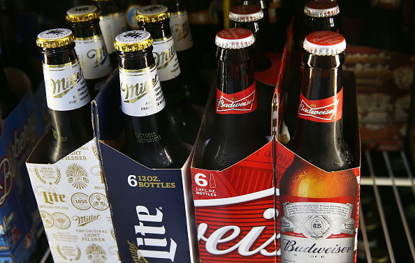 In this photo illustration, bottles of Budweiser and Miller Lite beer are seen on September 16, 2015 in Miami, Florida. Belgium's Anheuser-Busch InBev, which owns Budweiser and is the worlds largest brewer, is reported to be in takeover talks for the number two positioned British-based SABMiller, owner the Miller beers. (Photo Illustration by Joe Raedle/Getty Images)