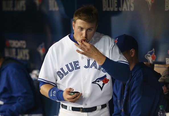  Justin Smoak #13 of the Toronto Blue Jays puts chewing tobacco in his mouth in the dugout during MLB game action against the New York Yankees on September 21, 2015 at Rogers Centre in Toronto, Ontario, Canada. (Photo by Tom Szczerbowski/Getty Images).