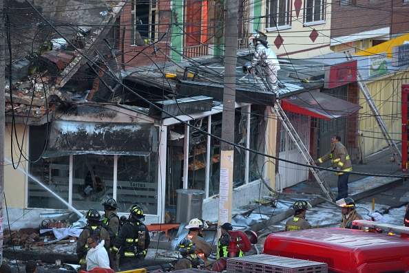 Rescue workers inspect the site of the aircrash  of BEECH-CRAFT60 plane in Engativa neighborhood, in Bogota, on October 18, 2015. A small plane crashed Sunday into a bakery in a crowded area of Colombia's capital, killing four people and injuring several others, authorities said. AFP PHOTO/Diana Sanchez        (Photo credit should read DIANA SANCHEZ/AFP/Getty Images).