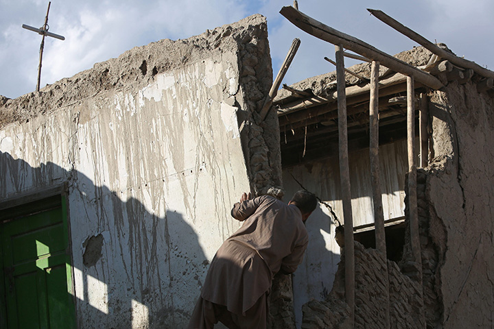 An Afghan man looks at a damaged house following a powerful earthquake today that could be felt across South Asia, in Kabul, Afghanistan, Monday, Oct. 26, 2015.