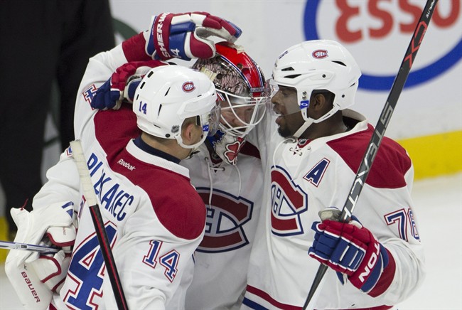 Montreal Canadiens defenceman P.K. Subban(right) and center Tomas Plekanec congratulate goalie Mike Condon as the Canadiens defeat the Ottawa Senators in NHL action Sunday, October 11, 2015 in Ottawa. 