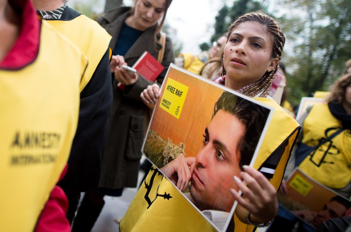Ensaf Haidar, wife of the imprisoned Saudi Arabian blogger, Raif Badawi, holds a sign reading '#FreeRaif' during an Amnesty International organized solidarity demonstration in front of the Saudi Arabian Embassy in Vienna, Austria, October 6, 2015.