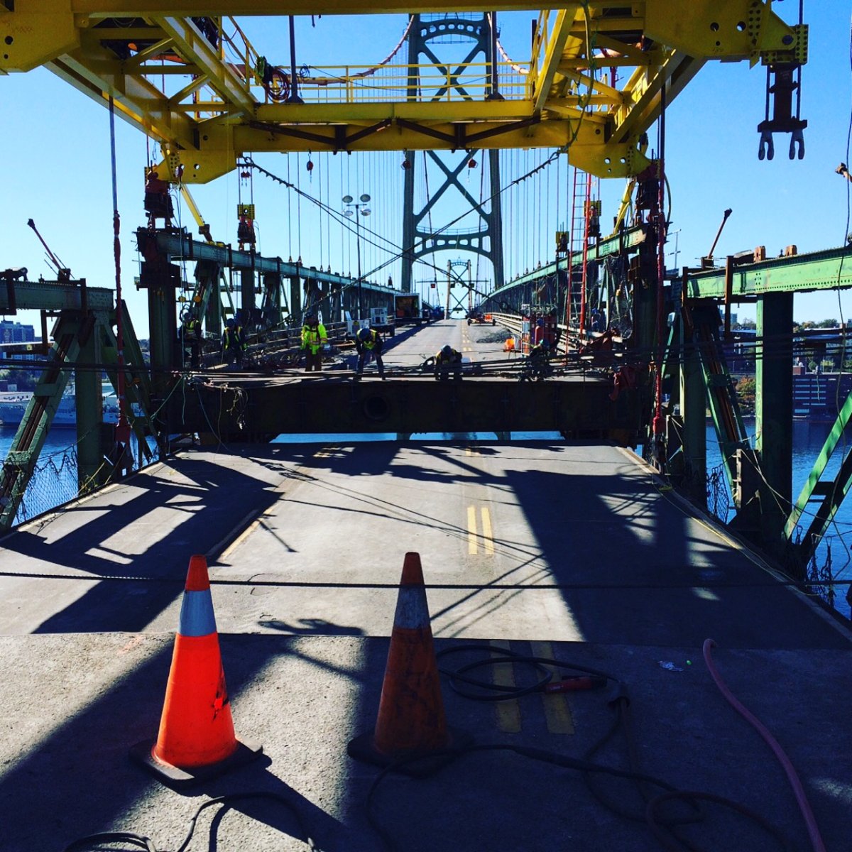 Workers carefully lower a section of the Macdonald Bridge. 