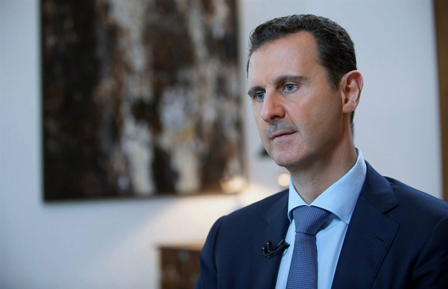 FILE - In this Sunday, Oct. 4, 2015 file photo released by the Syrian official news agency SANA, shows Syrian President Bashar Assad, speaking during an interview with the Iran's Khabar TV, in Damascus, Syria.