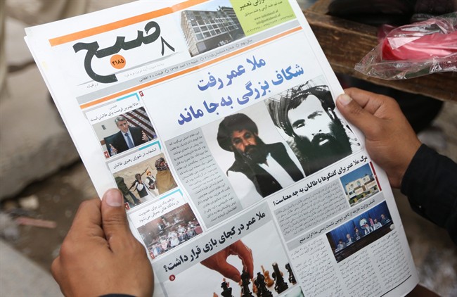 FILE - In this Saturday, Aug. 1, 2015 file photo, an Afghan man reads a local newspaper with photos of the new leader of the Afghan Taliban, Mullah Akhtar Mansoor, center, and former leader Mullah Mohammad Omar who was declared dead, in Kabul, Afghanistan.  (AP Photo/Massoud Hossaini, File).
