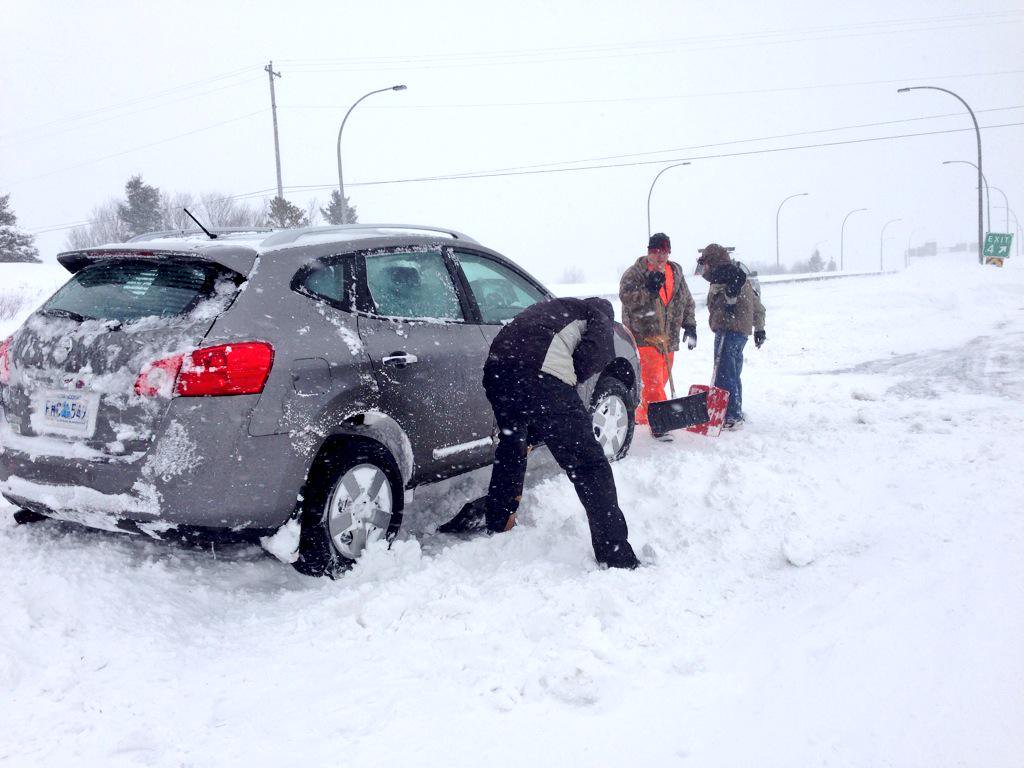 A car is shoveled out after getting stuck on a snowy Halifax road in March, 2015. 
