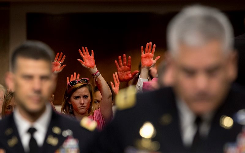 embers of CodePink protest the deadly American attack on a hospital in northern Afghanistan as U.S. Forces-Afghanistan Resolute Support Mission Commander Gen. John Campbell, right, testifies on Capitol Hill in Washington, Tuesday, Oct. 6, 2015, before the Senate Armed Services Committee hearing on the Situation in Afghanistan.