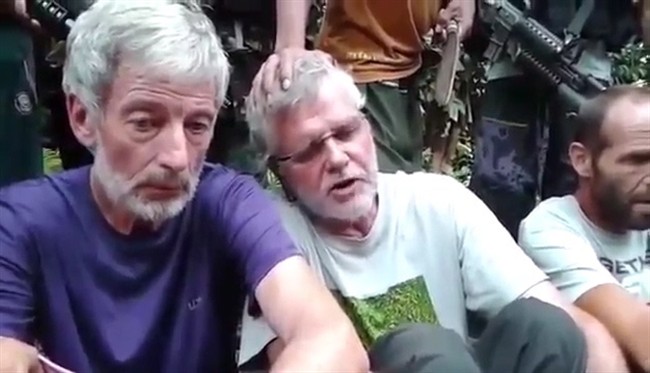 Robert Hall, left, and John Ridsdel are seen in this still image taken from a militant video released in October. In a new video, posted online Thursday, militants set a new April 25 deadline for their demands to be met. (File photo).