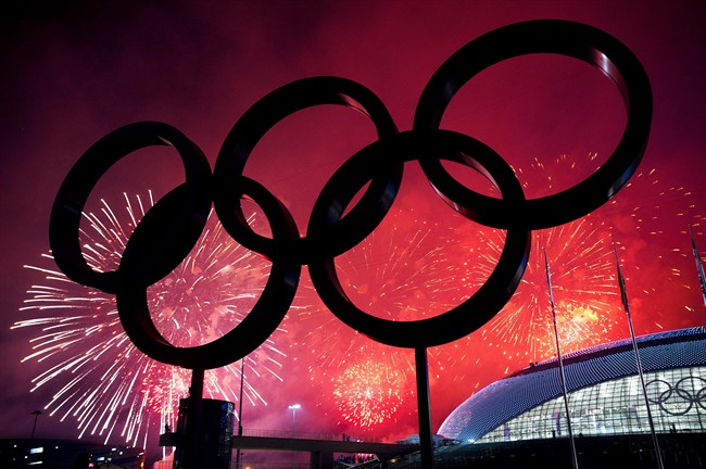 The Olympic Rings are silhouetted as fireworks light up the sky during the closing ceremonies at the 2014 Sochi Winter Olympics in Sochi, Russia on Sunday, February 23, 2014.