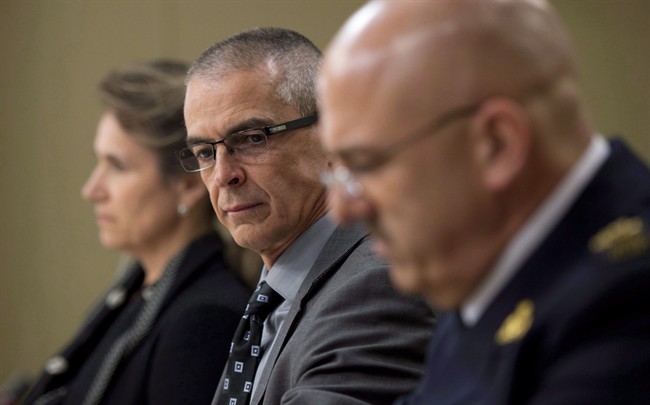 CSIS director Michel Coulombe, centre, waits with RCMP deputy commissioner Mike Cabana, right, and Greta Bossenmaier, Communications Security Establishment chief, to appear at the Senate national security committee to discuss the anti-terrorism act, Bill C-51 in Ottawa, April 20, 2015.