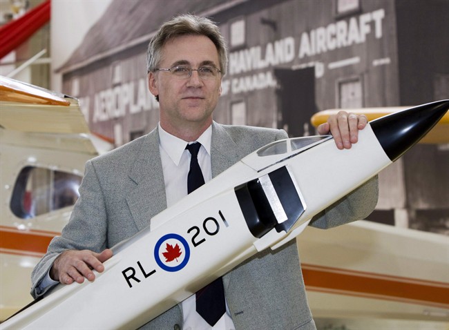 Canadian Air and Space Museum's Robert Godwin poses with a model of the Avro Arrow at the museum in Toronto on Monday July 13, 2009. Space historian Godwin says a Canadian university principal proposed rocket-based spaceflight 30 years earlier than previously thought.