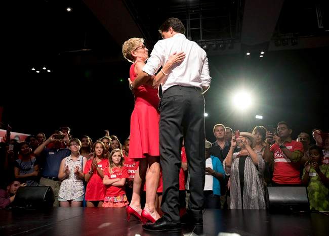 Liberal Leader Justin Trudeau, right, shares a moment on stage with Ontario Premier Kathleen Wynne during a stop along the federal election campaign trail in Toronto on August 17, 2015.