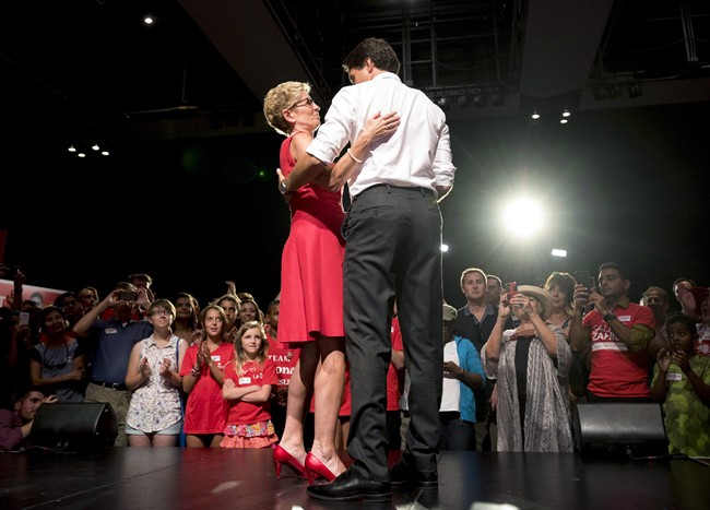 Liberal Leader Justin Trudeau, right, shares a moment on stage with Ontario Premier Kathleen Wynne during a stop along the federal election campaign trail in Toronto on August 17, 2015.