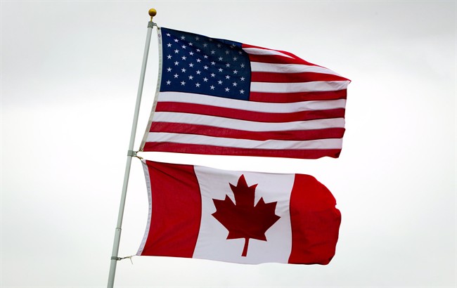 U.S. and Canadian flags fly in Point Roberts, Wash., on Tuesday, March 13, 2012.
