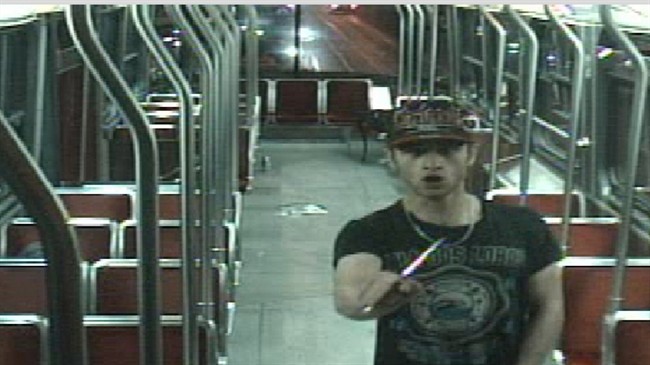 Sammy Yatim holds a knife while on a streetcar in Toronto on July 26, 2013 in this still taken from court handout surveillance video. A Toronto jury that will decide the fate of a police officer accused in the shooting death of 18-year-old Sammy Yatim watched several videos of the incident Wednesday showing the teen crumple to the floor of an empty streetcar. 