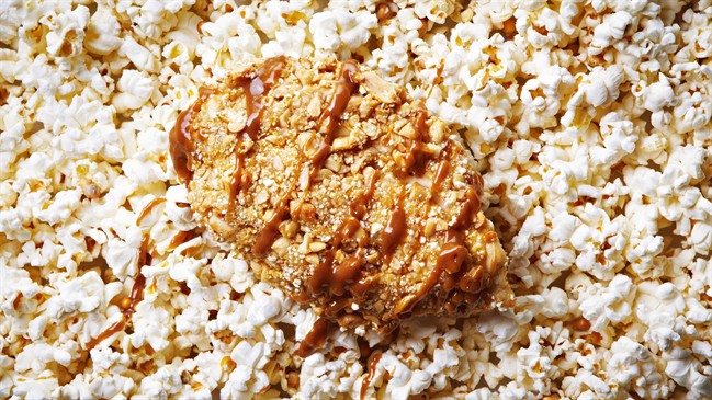 This recipe for peanut- and popcorn-crusted chicken is juicy on the inside, crunchy on the outside and topped with an Asian-style peanut sauce. 