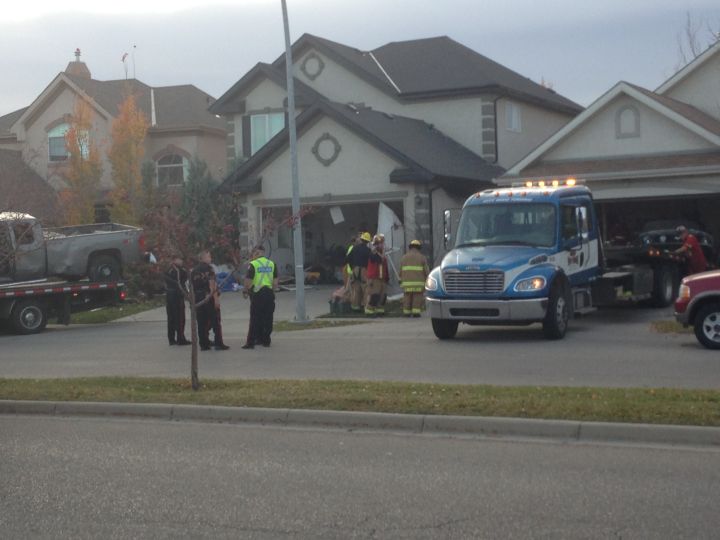 Driver dead after pickup truck crashes through 2 garages in southeast