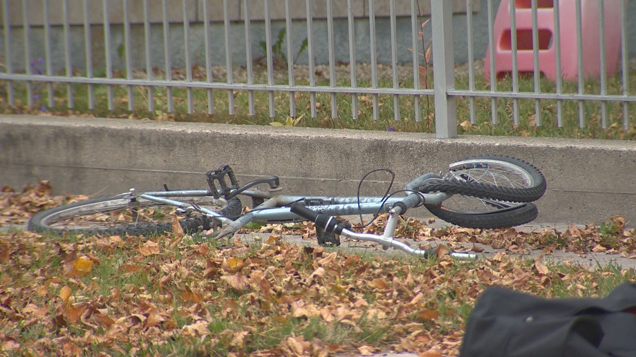 A bicycle lies on the side of the street, heavily damaged, after its rider collided with a vehicle Thursday morning. 