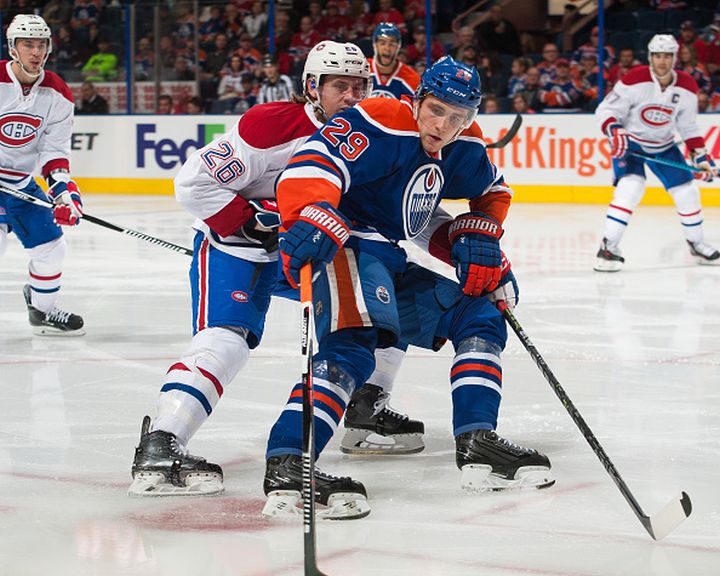 Leon Draisaitl #29 of the Edmonton Oilers battles for the puck against Jeff Petry #26 of the Montreal Canadiens on October 29, 2015 at Rexall Place in Edmonton, Alberta, Canada. 