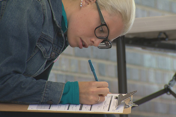A student fills out a form to be able to vote