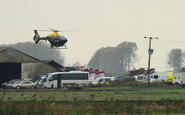 Emergency services and military personnel attend the scene after a U.S. military fighter jet pilot was killed after his U.S. F-18 Hornet crashed into farm fields in Redmere, Suffolk, Britain on October 21, 2015. 