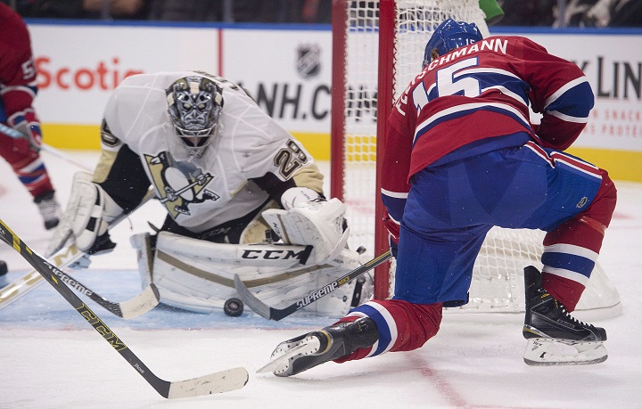 Montreal Canadiens' Tomas Fleischmann, right, shoots on Pittsburgh Penguins' goalie Marc Andre Fleury during second period of NHL exhibition hockey action on Monday, September 28, 2015, at the Videotron centre in Quebec City. Fleischmann and the Canadiens agreed to a one-year contract reportedly worth $750,000 on Sunday, Oct. 4, 2015.