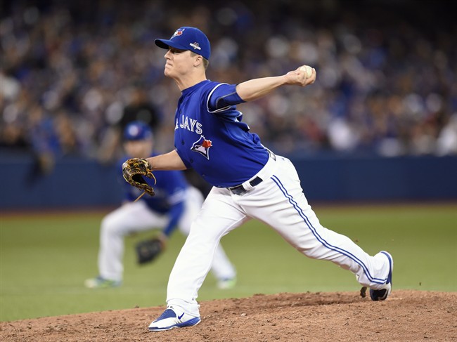 Toronto Blue Jays' Aaron Loup works against the Texas Rangers during twelfth inning of game two American League Division Series baseball action in Toronto on Friday, Oct. 9, 2015.