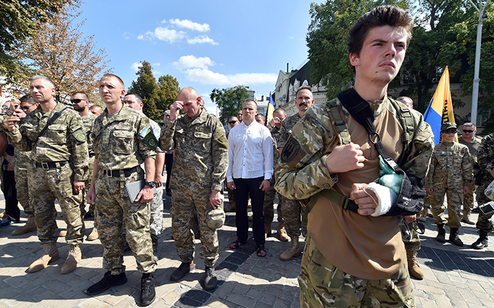 A wounded Ukrainian serviceman looks on during a memorial ceremony on August 29, 2015 in Kiev. 