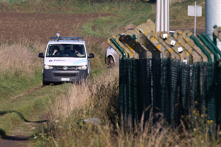Police patrol the perimeter of the army barracks in Flawinne, Namur Province, on October 26, 2015, after a man attempted to drive through the barriers. According to newspaper La Derniere Heure, gun shots were heard being fired on early October 26. 