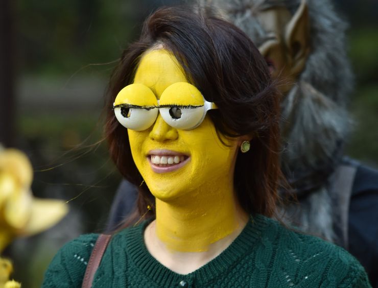 A woman wearing a Simpsons face mask takes part in a Halloween parade on a street in Kawasaki on October 25, 2015. 