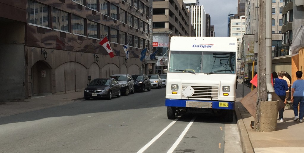 A Canpar delivery truck parked in the painted Hollis Street bike lane. 