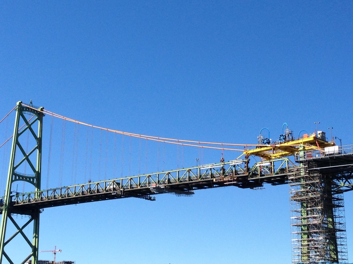 The first deck segment of the Macdonald Bridge was carefully lowered to the ground on Saturday.