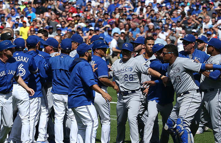 Salvador Perez of the Kansas City Royals is held back by teammates as both benches clear in the eighth inning during MLB game action against the Toronto Blue Jays on August 2, 2015 at Rogers Centre in Toronto.