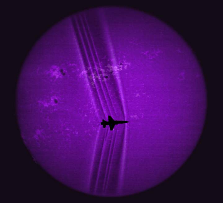 A jet is seen producing a shock wave across the face of the sun seen through a calcium-K filter.